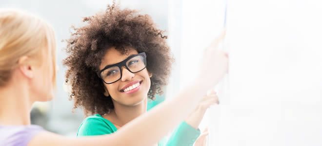 Two young woman collaborating